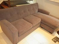 Front three-quarter view of complete sectional showing sofa and chaise placement