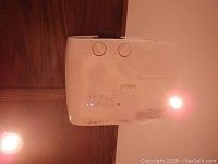 Front and side view showing lens, focus and zoom dials and indicator lights