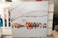 Full view of square acrylic painting depicting colorful birds on branch with faint sketch-like trees in background, on wooden stretcher frame.