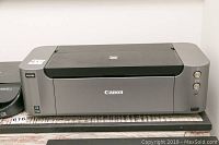 Front view of Canon Pro-100 photo printer showing model label and condition.