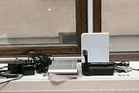 Overall view of Canon battery grip, WD external drive, USB adapter, charger and cables on window sill