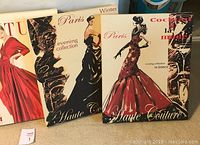 Five framed acrylic paintings on canvas with fashion-themed illustrations, showing various women in elegant dresses and couture styles.