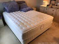 Queen mattress, box spring and frame installed in bedroom