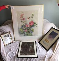 Five framed artworks arranged on a white backdrop including flowers watercolor, Renoir's The Swing, a soft color print, and a small black and white photo.