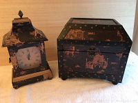 Photo showing black oriental style clock with pagoda top and matching rectangular box with metal clasp.
