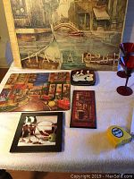 Large Italian themed wall art with text 'ITALIA 1926' and two red cocktail glasses with small plates and placemats on table.