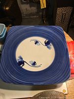 Blue ceramic serving dish showing blue gradient border with white center and blue floral design