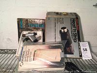 Lot of three heat-related tools: a Ronson Varaflame butane torch in box, Norelco fabric steamer in original packaging, and Black & Decker Heat 'n Strip heat gun boxed.