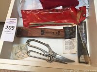 Photo showing Hoffritz wooden Crock Stick sharpener, metal rods, two pairs of scissors, and diamond file packaging.