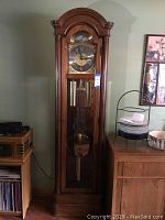 Full front view of oak longcase clock showing overall design and proportions