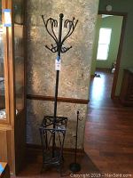 Photo showing full view of the black metal coat rack with umbrella stand base and the smaller adjustable stand beside it.
