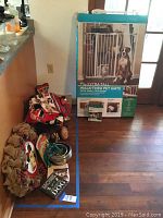 Overall view of all items including handmade dog pillow, dog leash, metal bowls, chew toy, care booklet and boxed YouMe pet gate.
