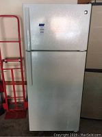 Front view of closed refrigerator showing white finish and top freezer door.