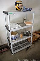 Photo showing the resin shelving rack holding various decorative and kitchen items.