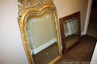 Both mirrors standing against wall, showing their size and frame details