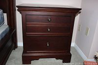 Front view of the two drawer end table showing its dark brown finish and classic design.