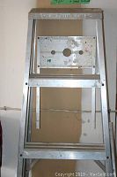 Front view of the aluminum step ladder showing flat steps and top platform with label.