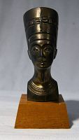 Front view of Queen Nefertiti brass head statuette on wooden base