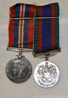 Front side of both medals with ribbons visible, showing King George VI War Medal on the left and Canadian Volunteer Service Medal on the right