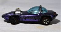 Side view of the vintage purple Hot Wheels Silhouette with blue dome and redline tires, showing wear and paint chips.