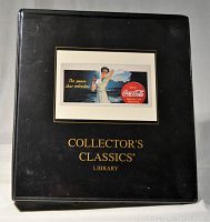 Black leather-like Coca-Cola Collector's Classics Library binder with vintage ad on front