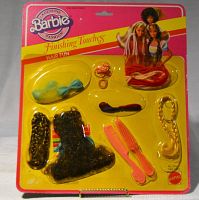 Front view of unopened Barbie Finishing Touches Hair Fun set showing all hair accessories in clear yellow plastic packaging on pink and yellow cardboard backing.