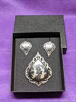 Photo of Siam sterling silver nielloware demi-parure set displayed in black box, showing brooch and earrings clearly.