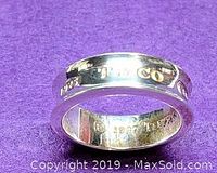Close up photo of sterling silver Tiffany ring highlighting engravings