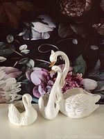 Both swan planters together showing size difference and condition