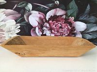 Side view of the solid wood carved rectangular bowl showing the natural wood grain and smooth finish.