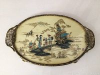 Full oval tray view showing scenic oriental inlay and brass filigree frame with handles