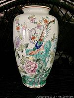 Front angle view of a ceramic vase showing bird and floral design on a white background