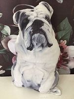 Front view of the bulldog shaped pillow showing detailed facial features and coloration resembling a bulldog dog.