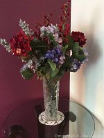 Full view of the crystal vase with faux flower arrangement showing colors and size.