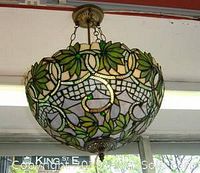 Assembled Tiffany-style chandelier hanging from ceiling showing leaf pattern and bowl shape