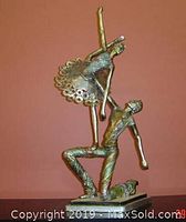 Side view of ballerina and male dancer figurines showing dynamic dance pose and tutu details.