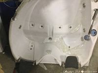 White acrylic corner tub shell showing built-in jets and headrest support areas
