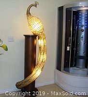 One lamp illuminated beside a pedestal and shower stall