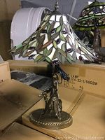 Tiffany style lamp with stained glass leaf motif shade showing full lamp