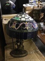 Full view of one lamp in front of shipping boxes