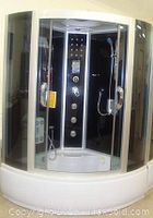 Full front view of assembled steam shower cabin showing curved acrylic base and glass enclosure