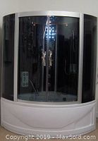 Front view of assembled shower enclosure with curved sliding doors and tempered glass panels