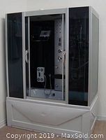 Assembled steam bath shower unit with tinted tempered glass panels and white acrylic base