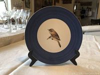 Marcel Guillot ceramic bird plate with brown bird on beige center and blue rim on stand