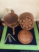 Wooden nut bowl with tripod stand, cheese dish, and carved wall decor pieces