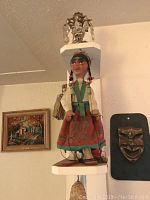 Full frontal view of female marionette string puppet dressed in traditional Mexican clothing.