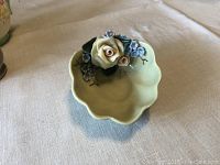 Close-up of Hazel McCoy hand painted ceramic ring keeper showing detailed attached flowers and scalloped edges