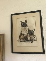Framed signed pastel artwork showing two Siamese cats, one sitting upright and the other reclining, signed by PP Bankston.