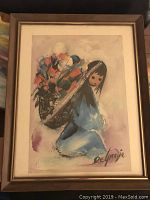 Framed De Grazia print art of a girl with flowers, signed.