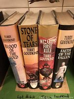 Photo of four hardback Terry Goodkind fantasy books showing spines 'Blood of the Fold', 'Stone of Tears', 'Wizard's First Rule', 'Faith of the Fallen'. Dust jackets on all four.